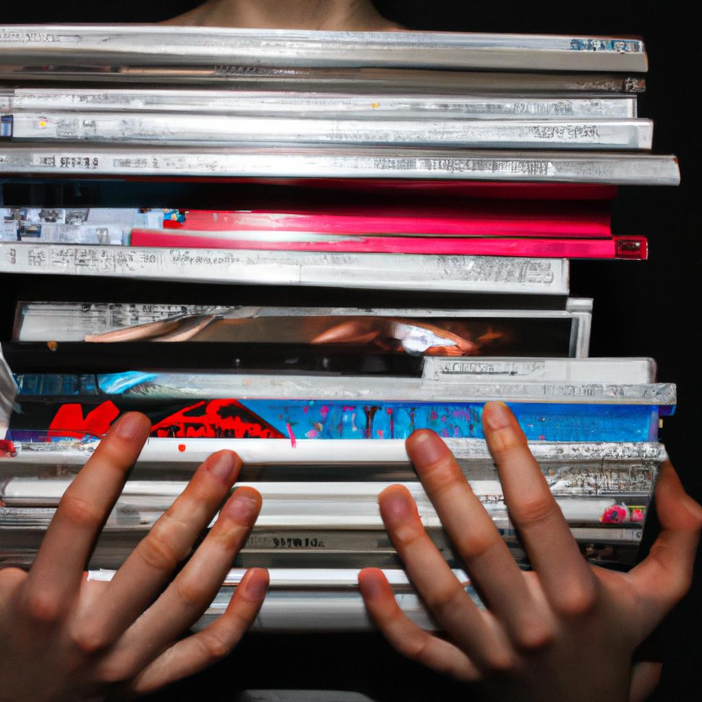 Person holding multiple album covers